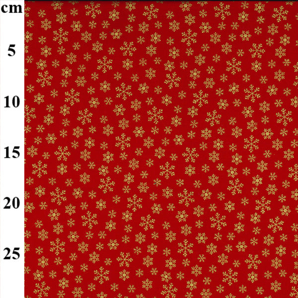 Red fabric with gold snowflake pattern and measurement scale
