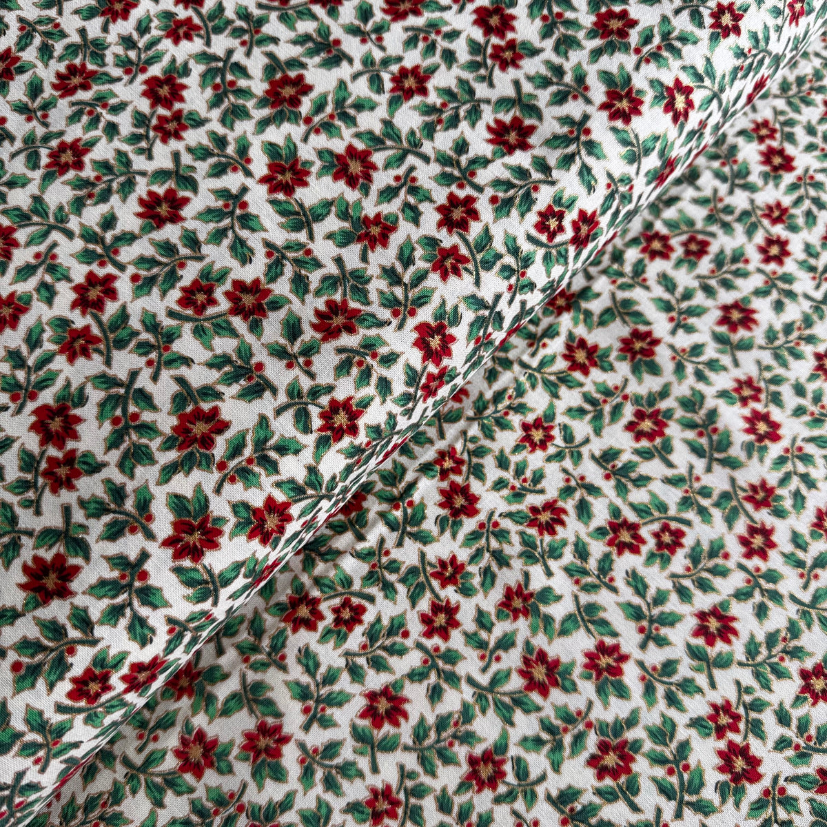 John Louden Christmas Poinsettia Sprigs on Cream Cotton Fabric at Bibelot Leek
