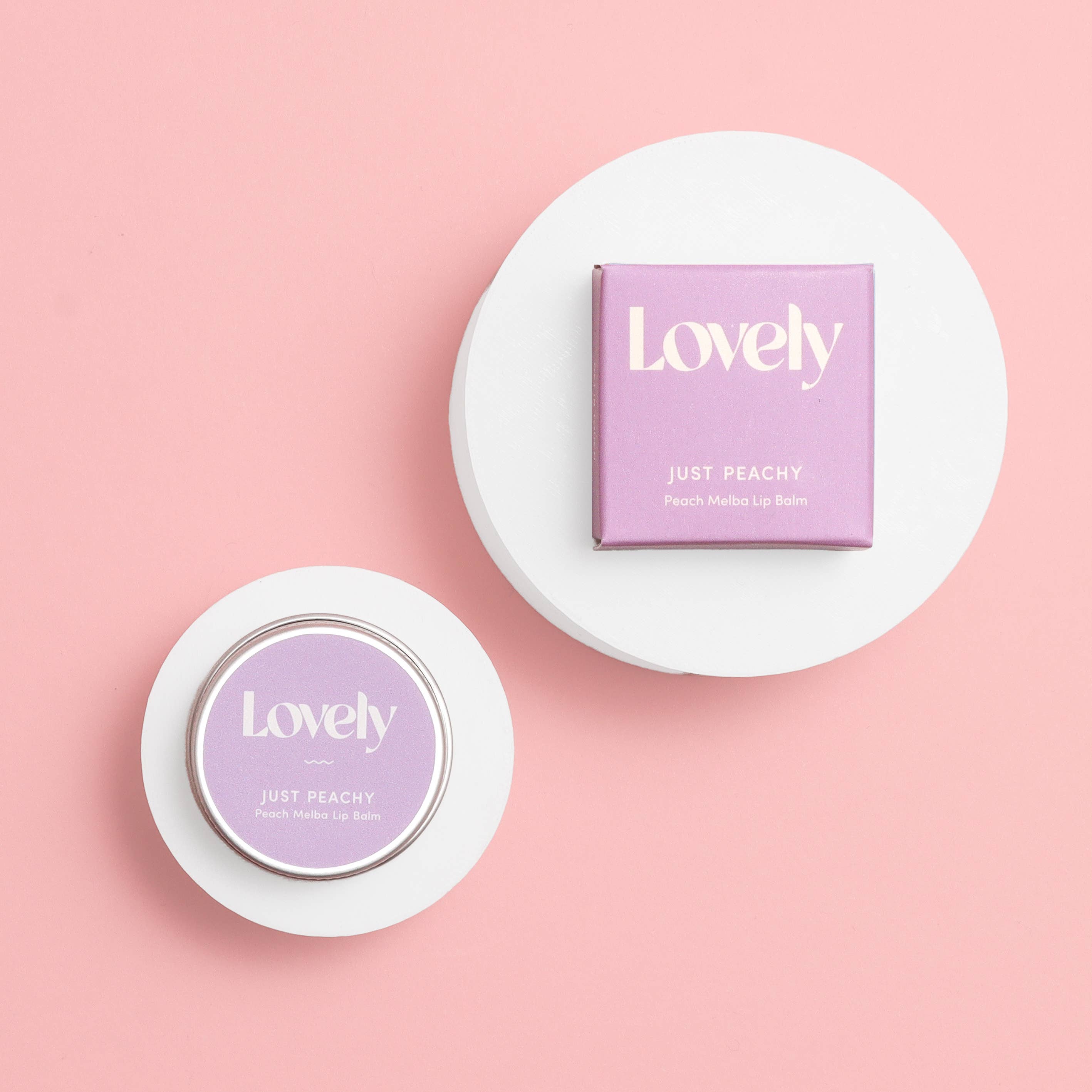 Lovely brand lip balm on a pink background