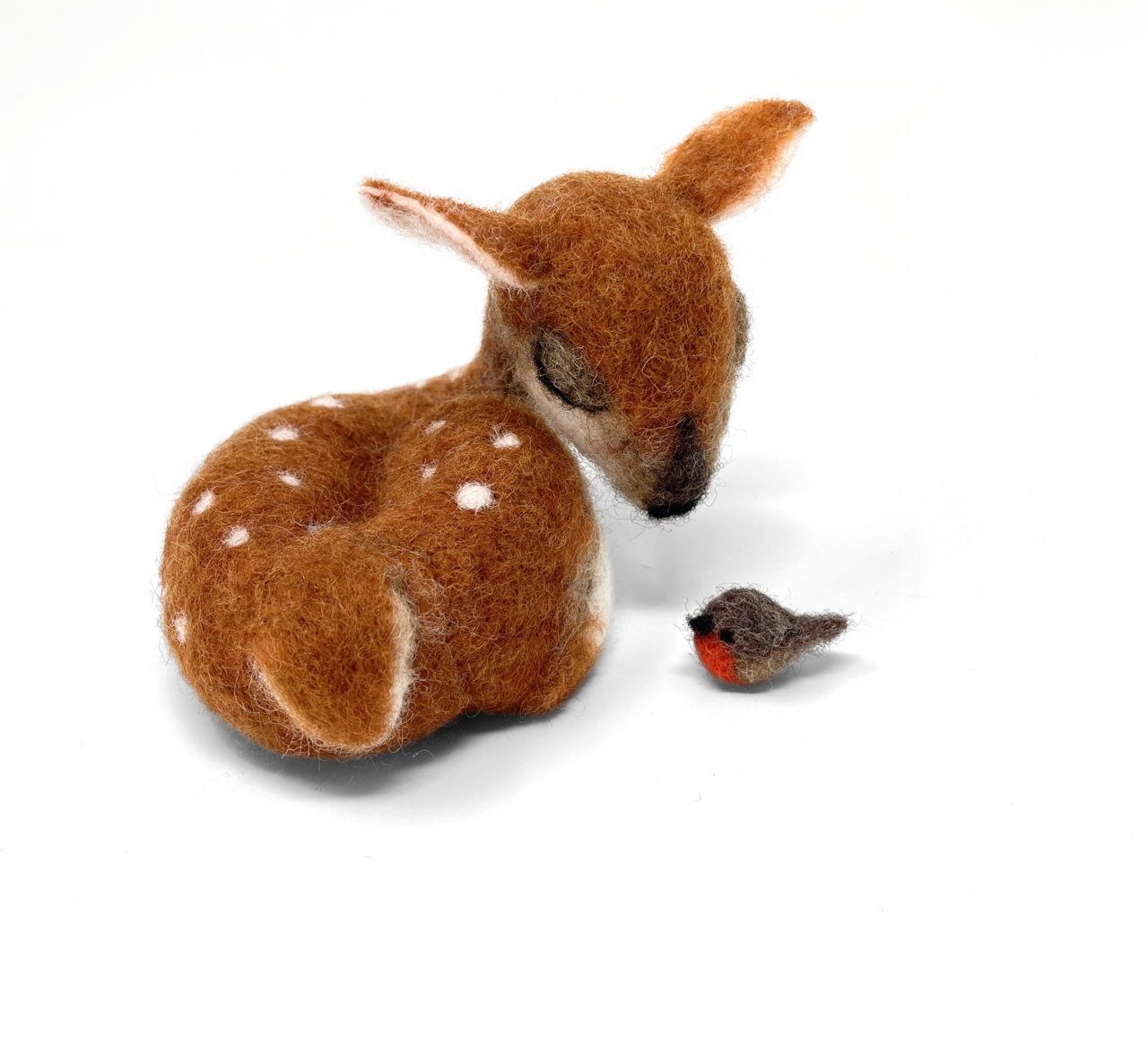 Stuffed deer and bird toy on a white background