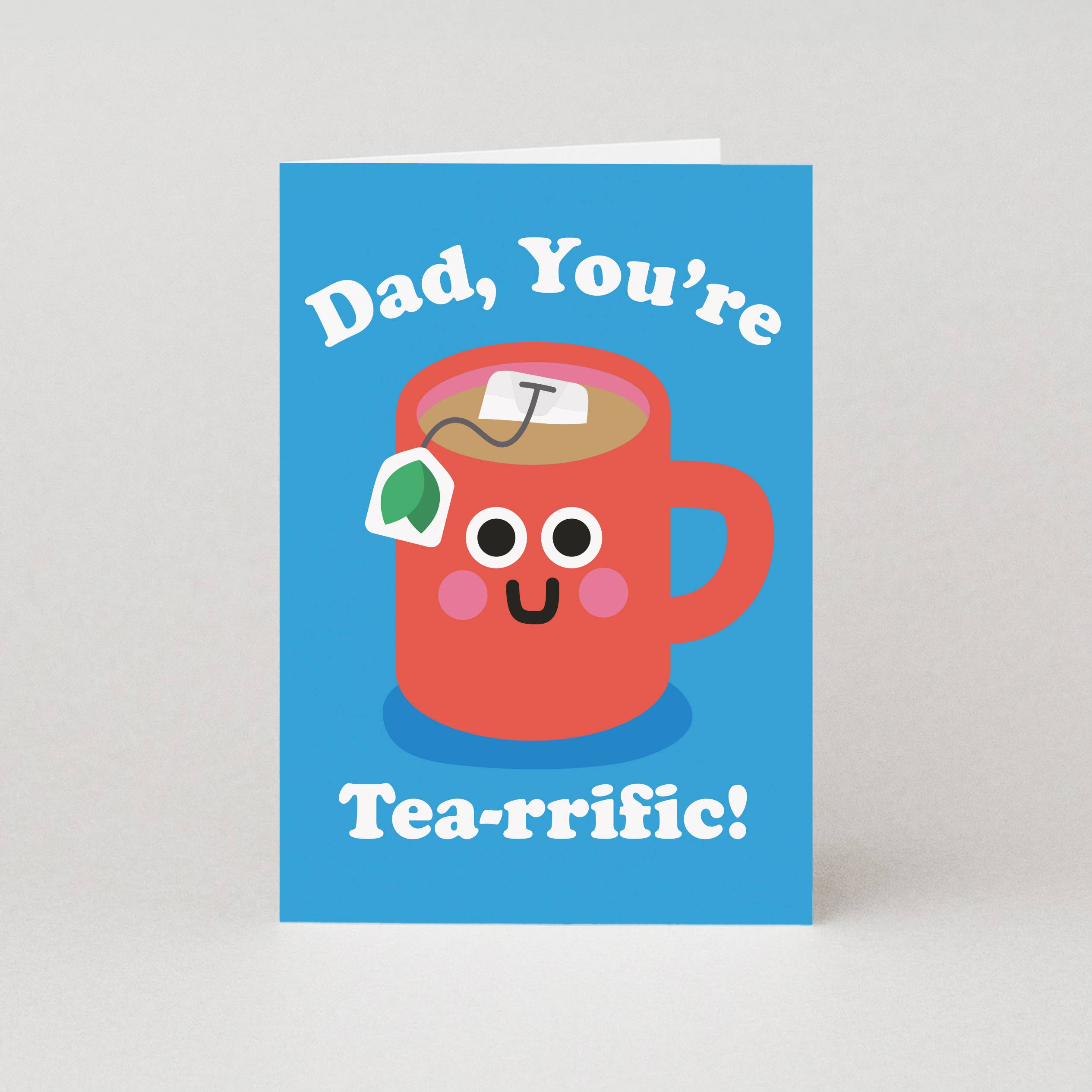 Greeting card with a cartoon red mug and tea bag on a blue background with text 'Dad, You're Tea-rrific!'.