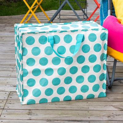 Polka dot storage bag with teal circles on a wooden deck