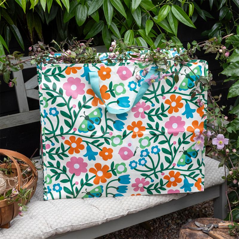 Floral-patterned storage bag with flowers on a bench outdoors