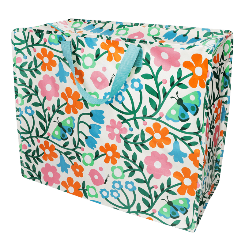 Floral and butterfly patterned storage bag with blue handles on a white background