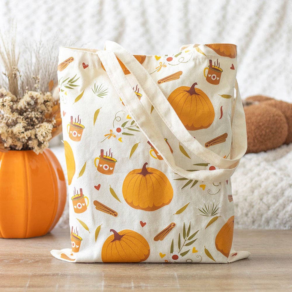 Fabric bag with autumn-themed pattern on a wooden surface