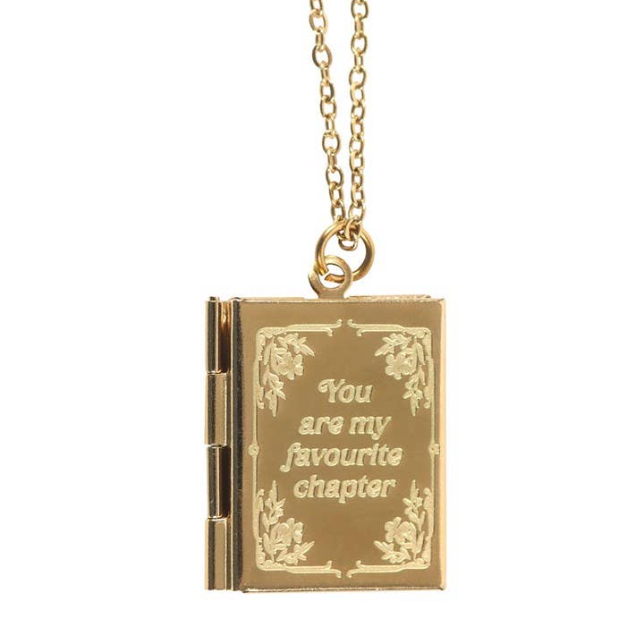Gold book-shaped pendant necklace with 'You are my favourite chapter' text on a white background