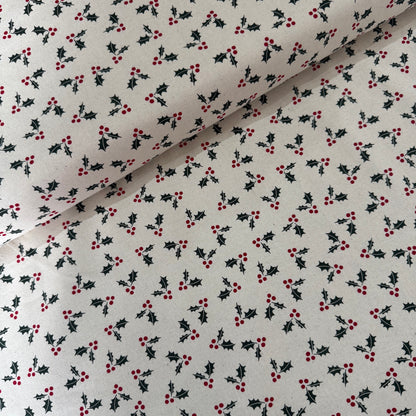 Fabric with holly berry pattern on a white background