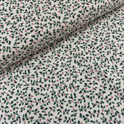 Fabric with holly berry pattern on a white background
