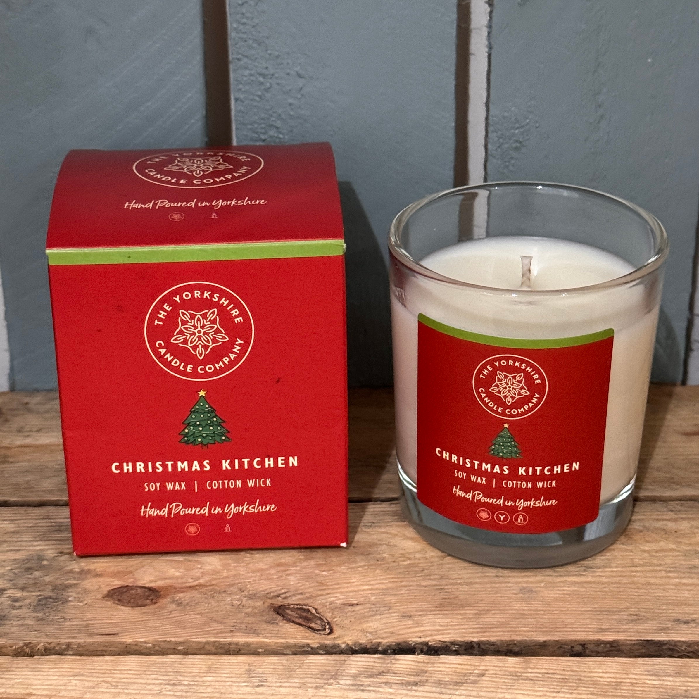 Candle and packaging of The Yorkshire Candle Company's 'Christmas Kitchen' candle on a wooden surface.