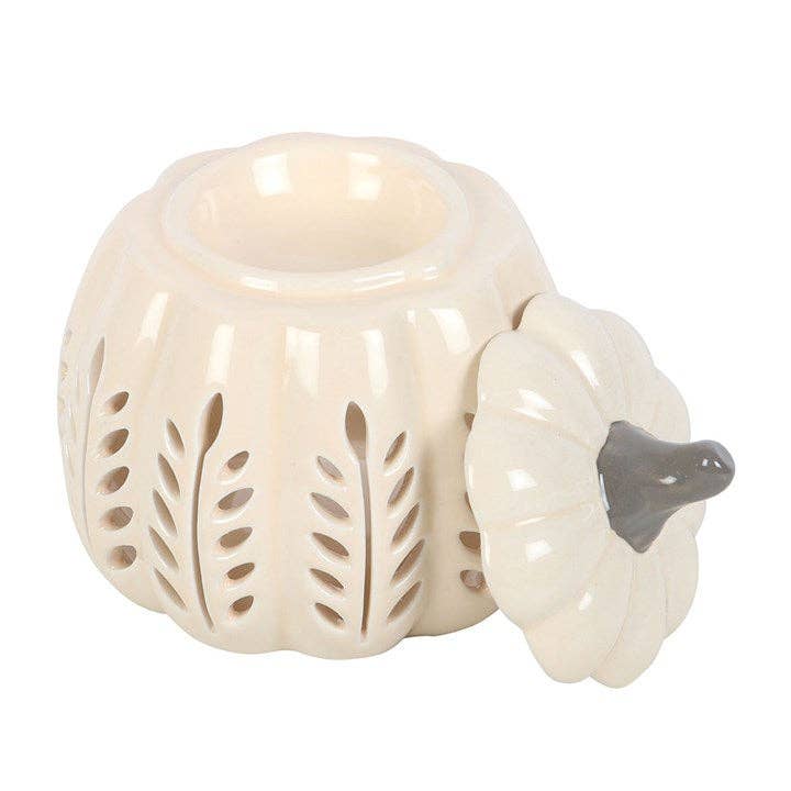 White ceramic pumpkin-shaped lantern with cut-out designs on a white background