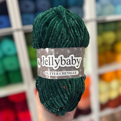 Green Jellybaby yarn ball held in front of a colorful yarn display
