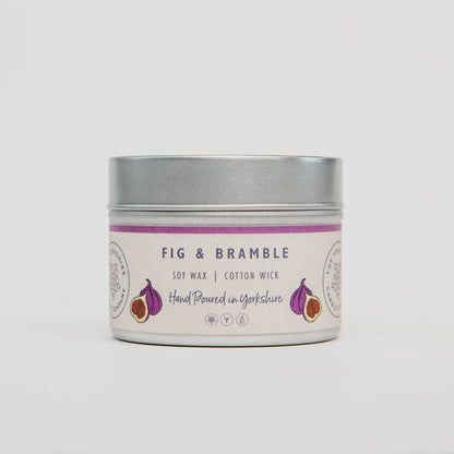 Candle in a tin with 'Fig & Bramble' label on a white background