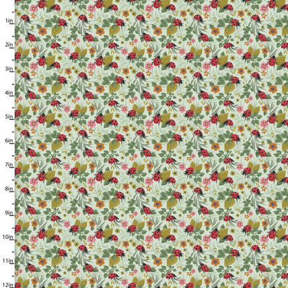 Floral patterned fabric with flowers and ladybugs on a green background