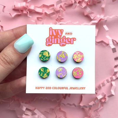 Set of colorful earrings on a 'ivy and ginger' card with pink confetti background