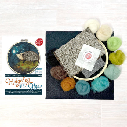 Needle felting kit with felted product, wool roving, and needle Felting Kit branding on a white background.
