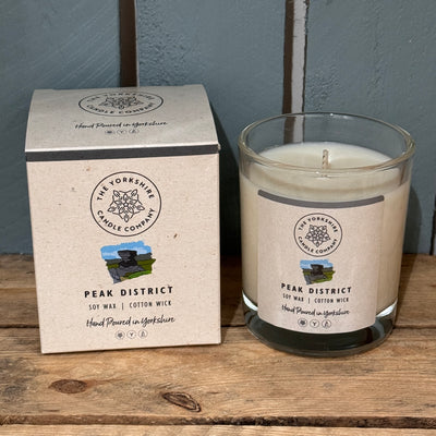 Candle tin labeled 'Peak District' with soy wax and cotton wick on a white background