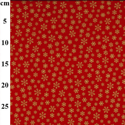 Red fabric with gold snowflake pattern and measurement scale