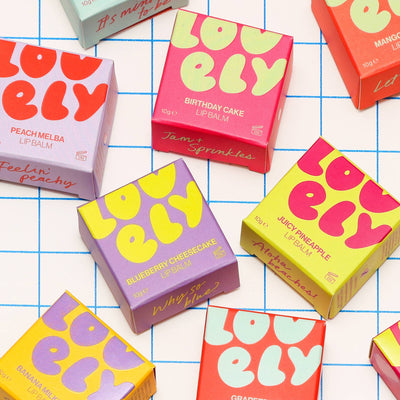 Colourful 'Lovely' lip balm boxes on a grid background at Bibelot Leek