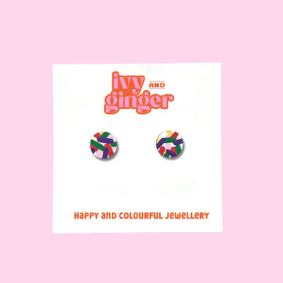 Colorful earrings on a card with 'ivy and ginger' branding on a pink background