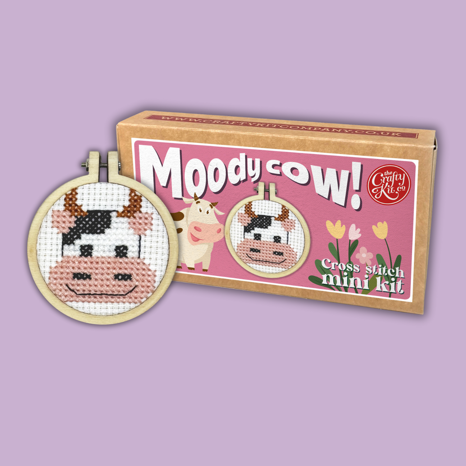Cross stitch mini kit with 'Moody Cow' design on a pink background