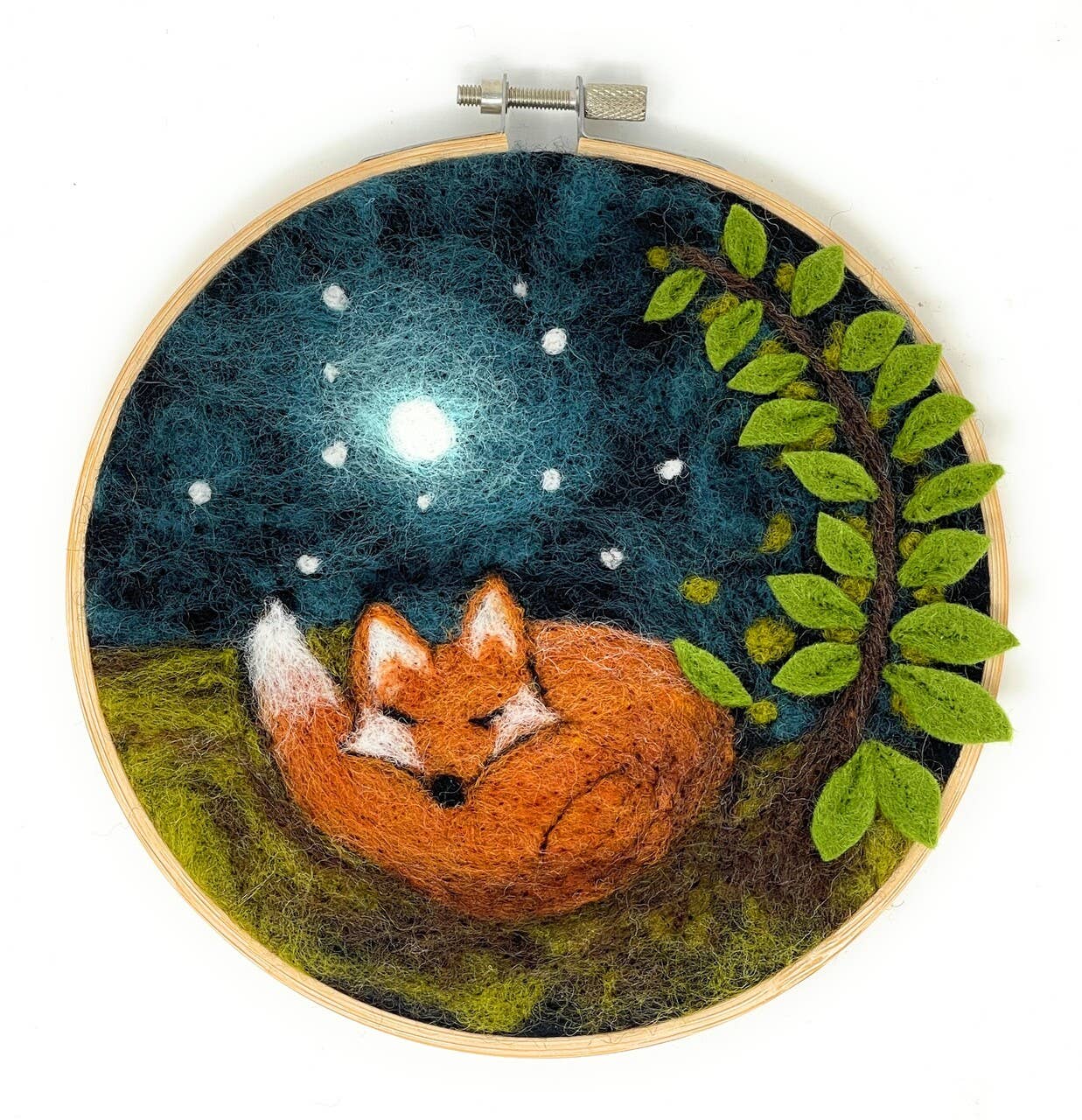 Embroidery hoop with a fox under a starry night sky