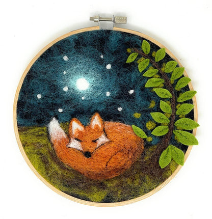 Embroidery hoop with a fox under a starry night sky