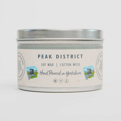Candle tin labeled 'Peak District' with soy wax and cotton wick on a white background