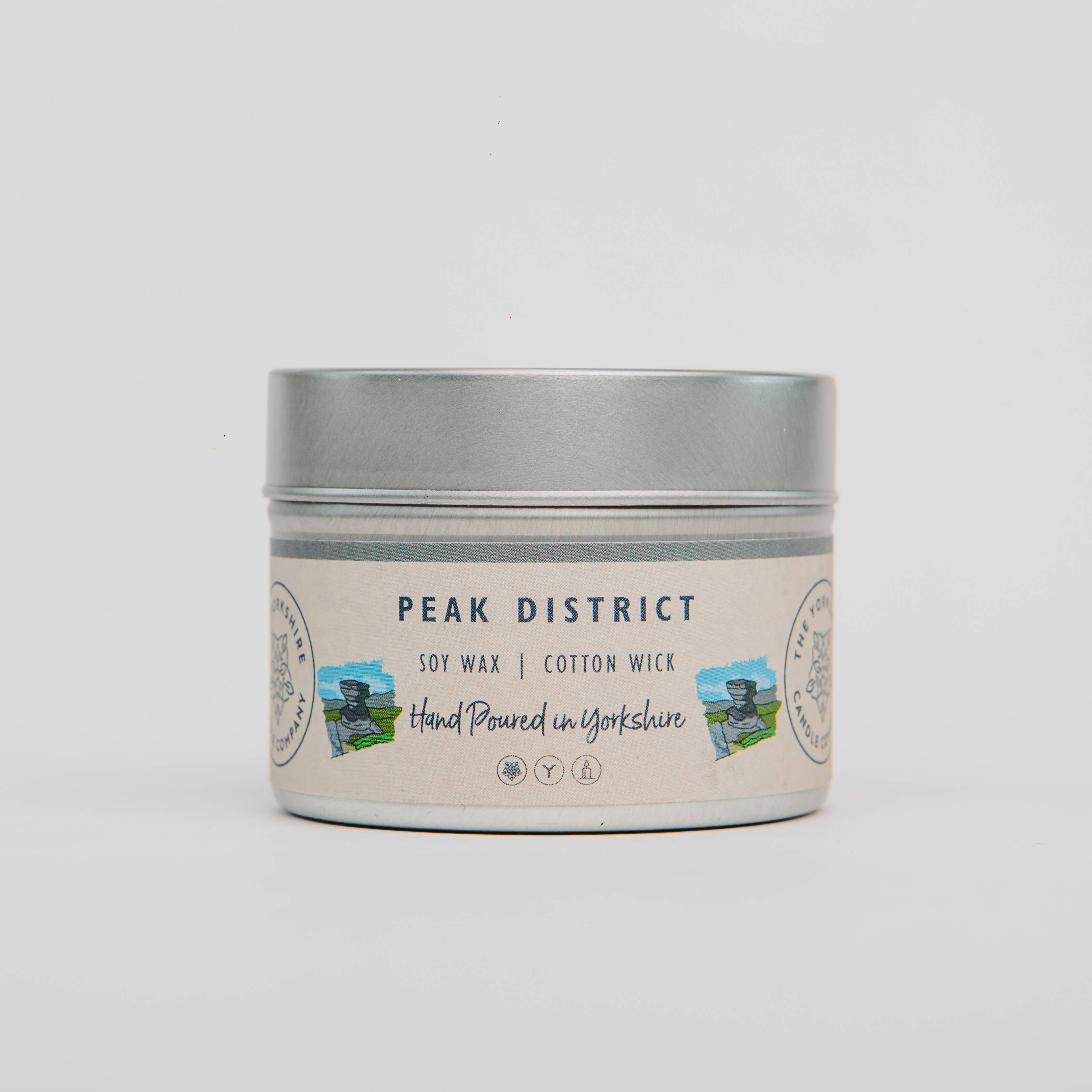 Candle tin labeled 'Peak District' with a scenic design on a light gray background