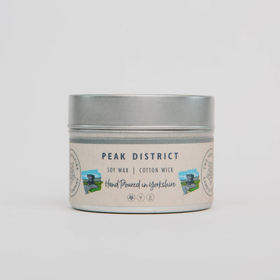Candle tin labeled 'Peak District' with a scenic design on a light gray background