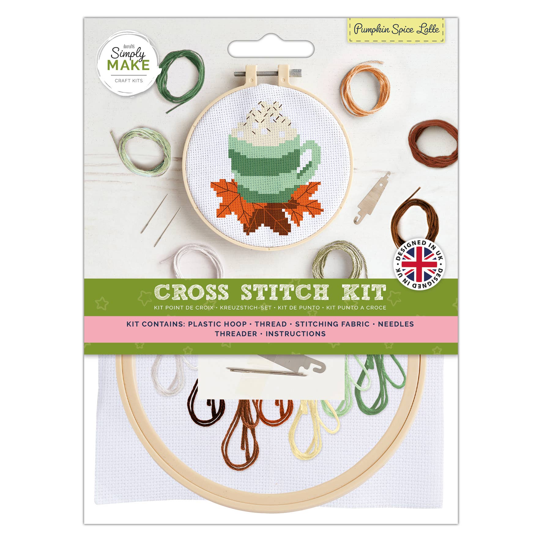 Cross stitch kit packaging with embroidery hoop and thread on a white background