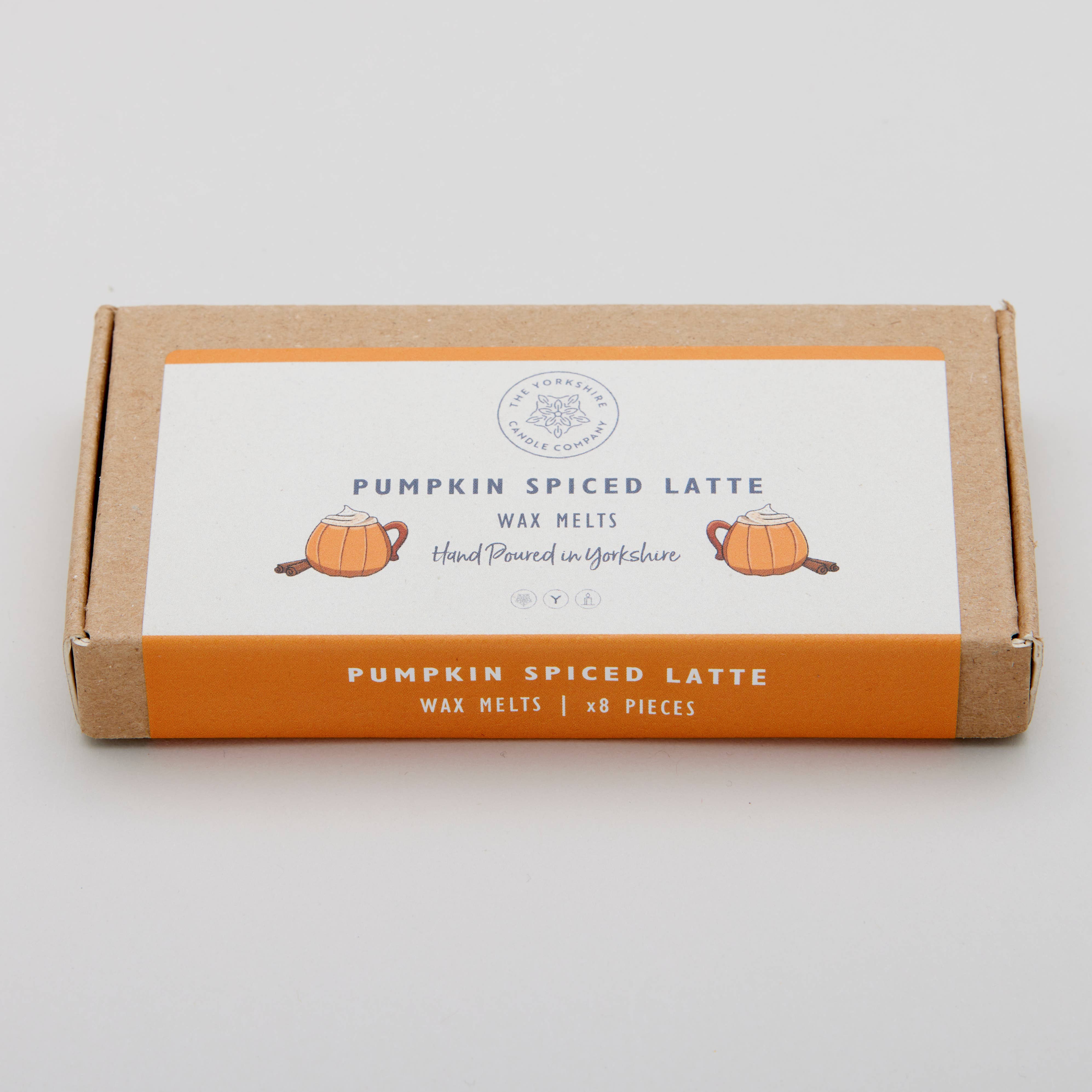 Box of pumpkin spiced latte wax melts on a light gray background