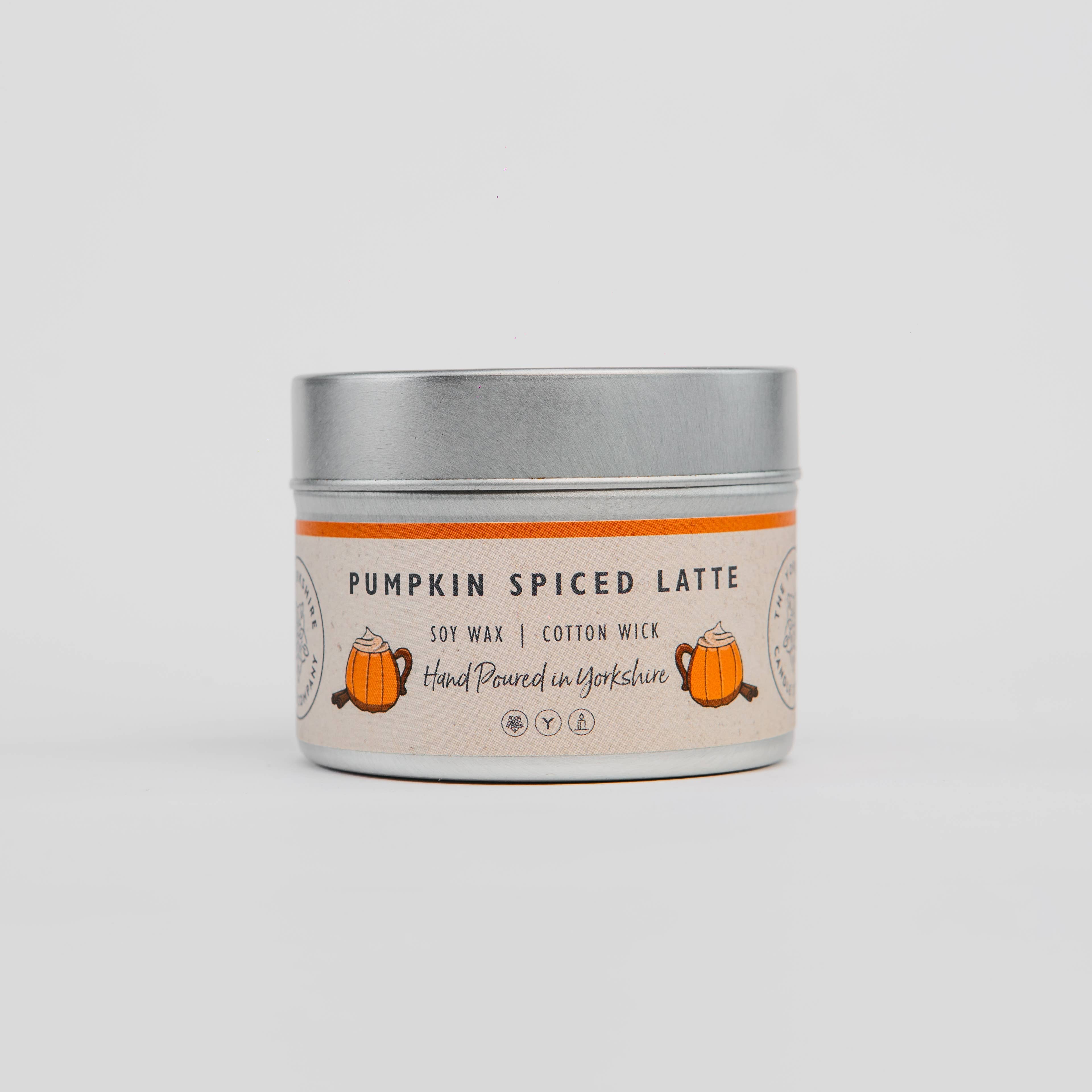 Candle tin labeled 'Pumpkin Spiced Latte' on a light gray background