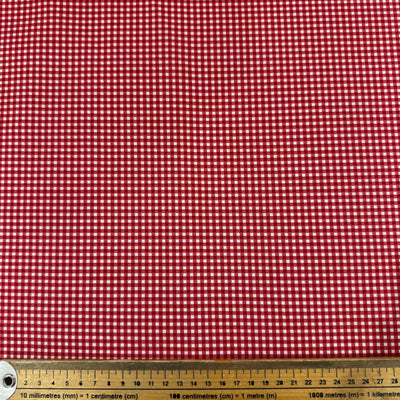 Red and white checkered fabric with a ruler at the bottom for scale.