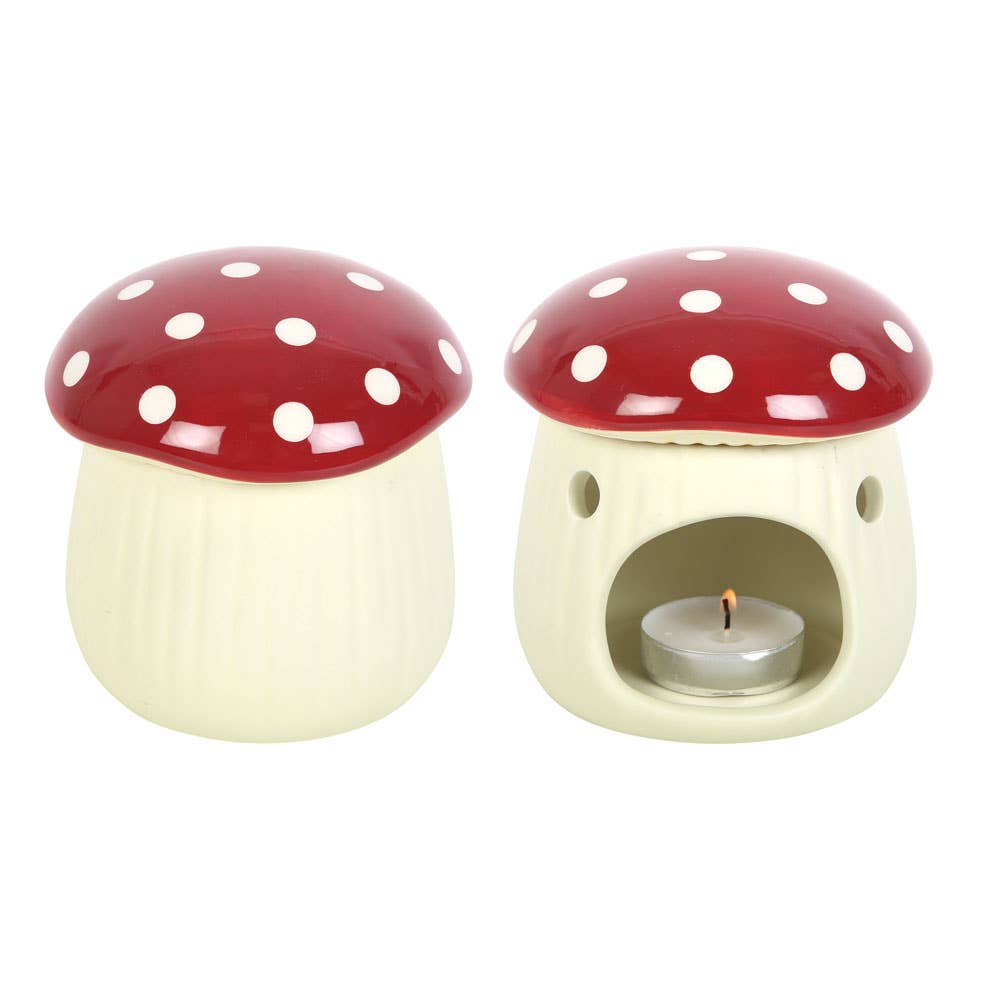 Ceramic mushroom-shaped oil burner with a lit candle inside on a white background