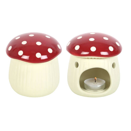 Ceramic mushroom-shaped oil burner with a lit candle inside on a white background