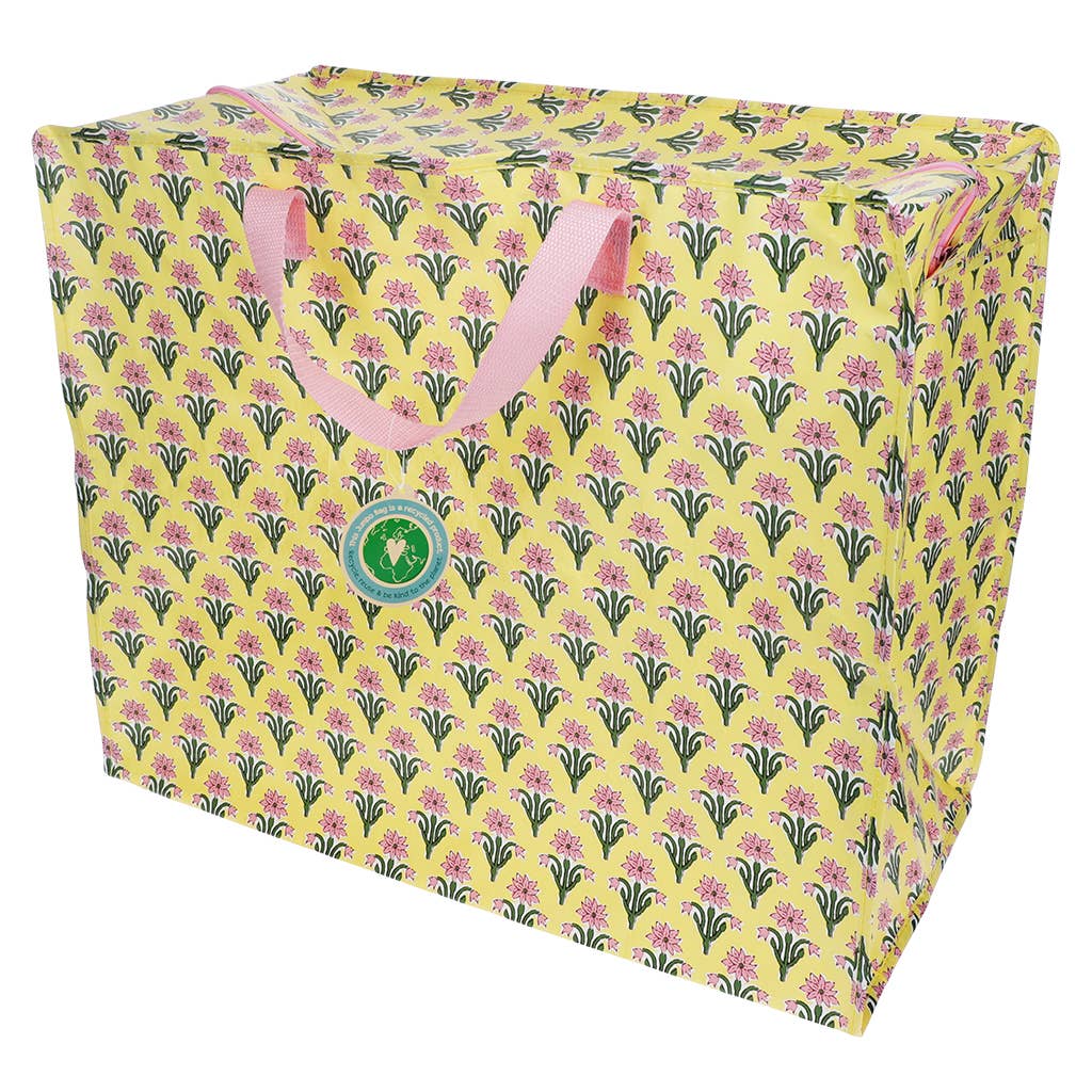 Floral-patterned tote bag with a visible brand logo on a yellow background