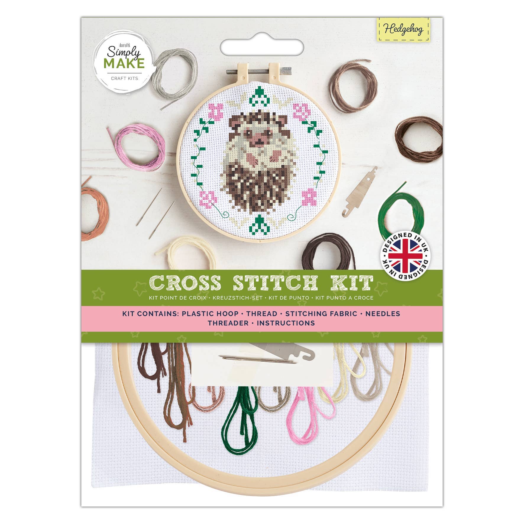 Cross stitch kit packaging with embroidery hoop and thread on a white background