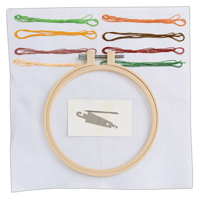 Embroidery hoop with colorful threads and a needle on a white background