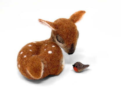 Stuffed deer and bird toy on a white background