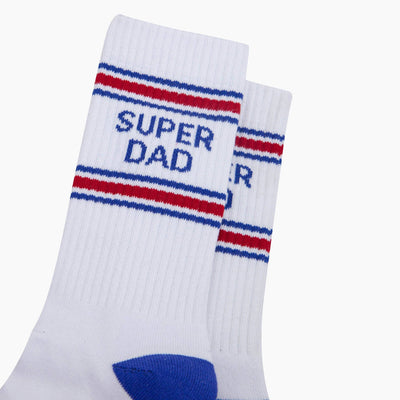 White socks with red and blue stripes and 'Super Dad' text on a white background