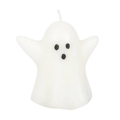 Ghost-shaped candle with black eyes and mouth on a white background