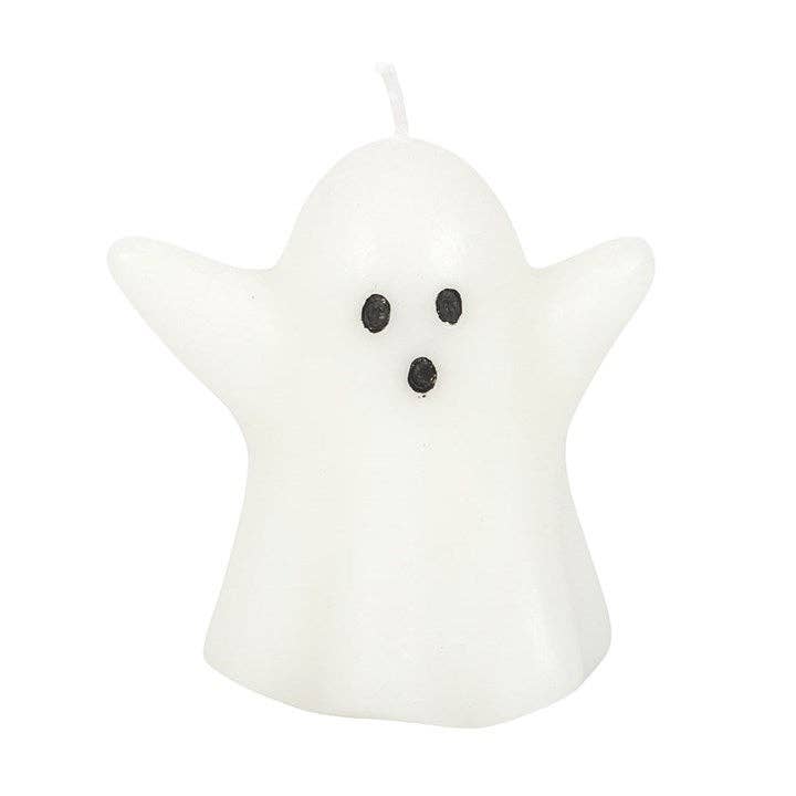 Ghost-shaped candle with black eyes and mouth on a white background