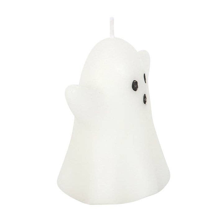 White ghost-shaped candle with black eyes on a white background
