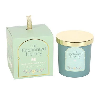Teal candle with gold lid and packaging labeled 'The Enchanted Library' on a white background