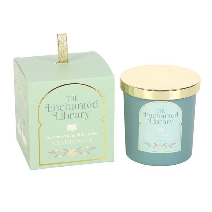 Teal candle with gold lid and packaging labeled 'The Enchanted Library' on a white background