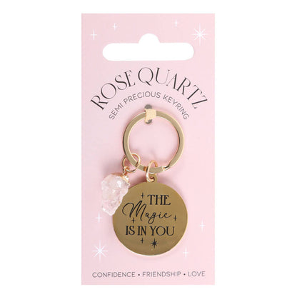 Keychain with 'The Magic is in You' tag on a pink packaging background