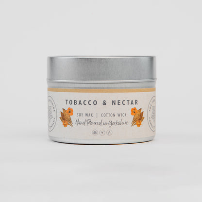 Candle tin labeled 'Tobacco & Nectar' on a white background