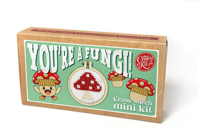 Cross-stitch mini kit packaging with cartoon mushrooms and text on a white background