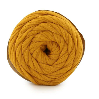 Mustard yellow yarn ball on a white background